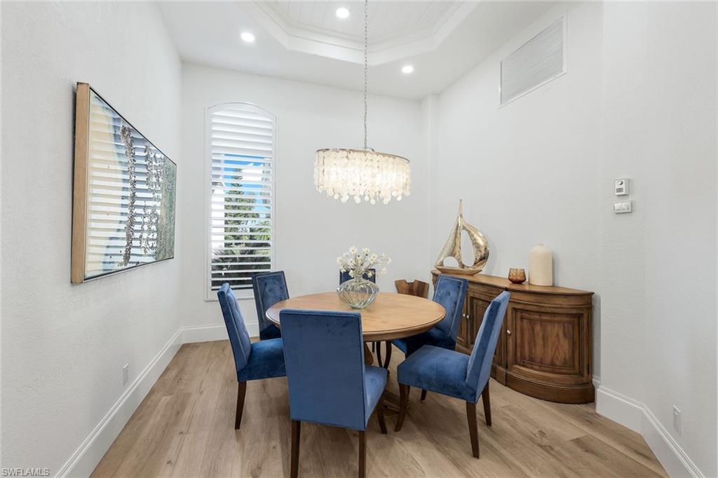 5092 Cerromar Drive Naples, FL 34112 - Photo 14 of 47 a view of a dining room with furniture window and wooden floor