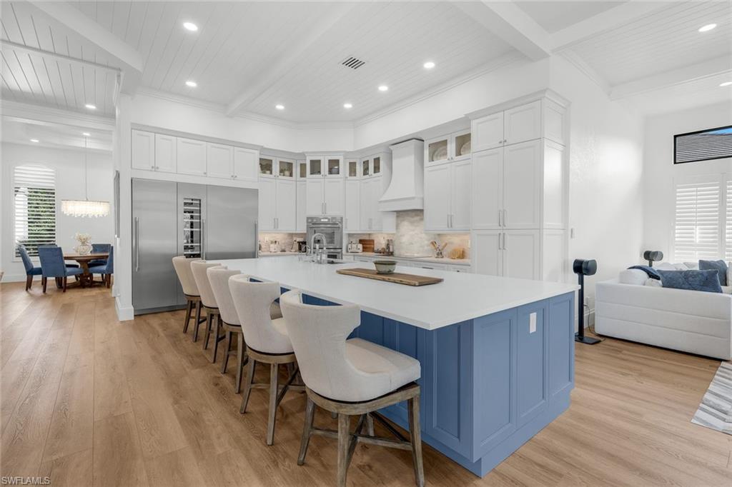 5092 Cerromar Drive Naples, FL 34112 - Photo 16 of 47 a kitchen with a dining table chairs refrigerator and a sink