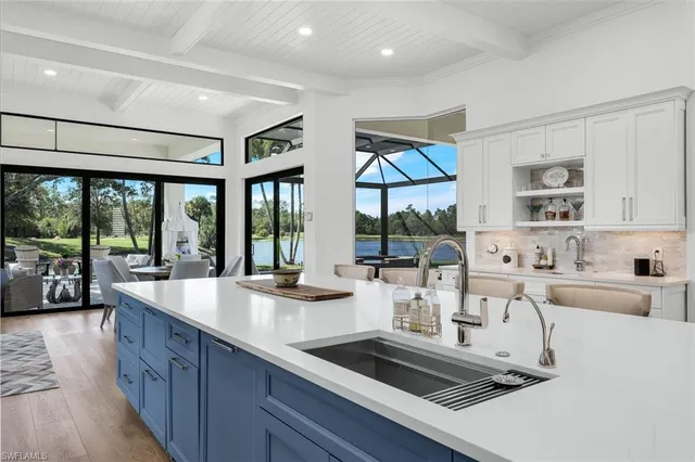 a large kitchen with kitchen island a sink a center island stainless steel appliances and a center island