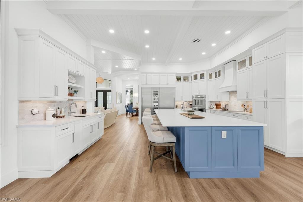 5092 Cerromar Drive Naples, FL 34112 - Photo 18 of 47 a large kitchen with kitchen island a sink a center island stainless steel appliances and a center island