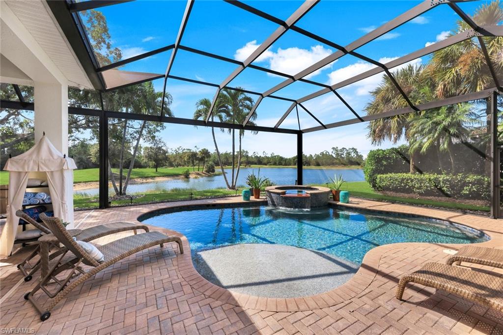 5092 Cerromar Drive Naples, FL 34112 - Photo 2 of 47 a view of a swimming pool with a patio