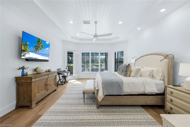 a large bathroom with a double vanity sink a toilet a mirror and shower