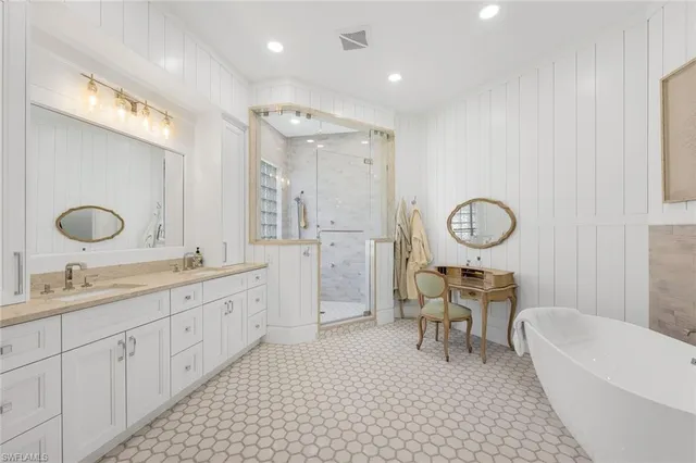 a bathroom with a granite countertop sink a mirror and shower