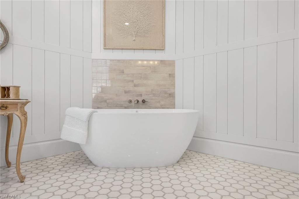 5092 Cerromar Drive Naples, FL 34112 - Photo 26 of 47 a white bath tub sitting in a bathroom