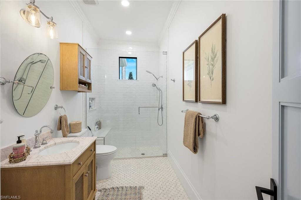 5092 Cerromar Drive Naples, FL 34112 - Photo 30 of 47 a bathroom with a tub sink and mirror