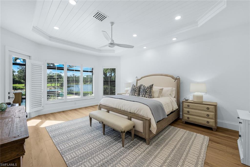 5092 Cerromar Drive Naples, FL 34112 - Photo 31 of 47 a spacious bedroom with a large bed and a window