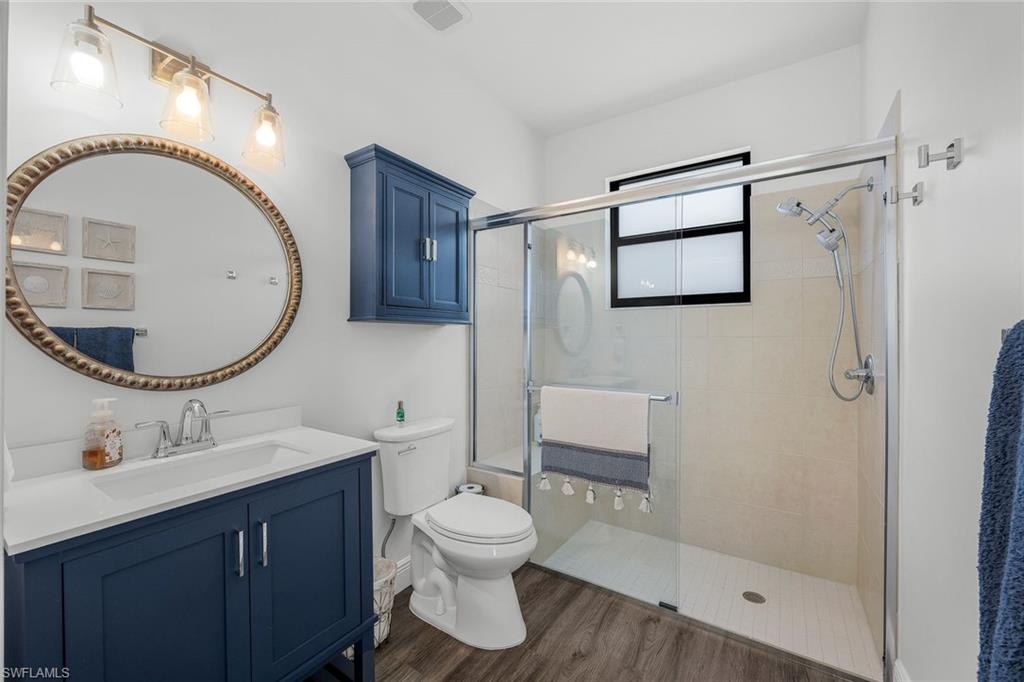 5092 Cerromar Drive Naples, FL 34112 - Photo 36 of 47 a bathroom with a toilet a sink and a mirror