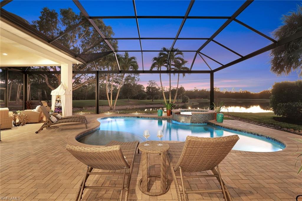 5092 Cerromar Drive Naples, FL 34112 - Photo 38 of 47 a view of a swimming pool with a patio