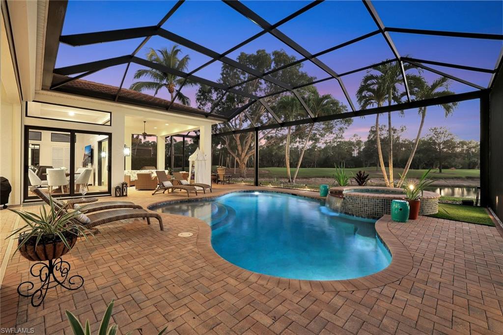 5092 Cerromar Drive Naples, FL 34112 - Photo 41 of 47 a view of a swimming pool with a patio