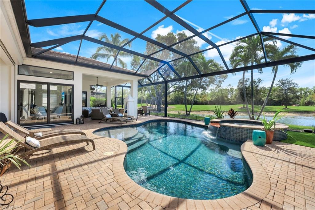 5092 Cerromar Drive Naples, FL 34112 - Photo 45 of 47 a view of a swimming pool with a couches chairs and a yard