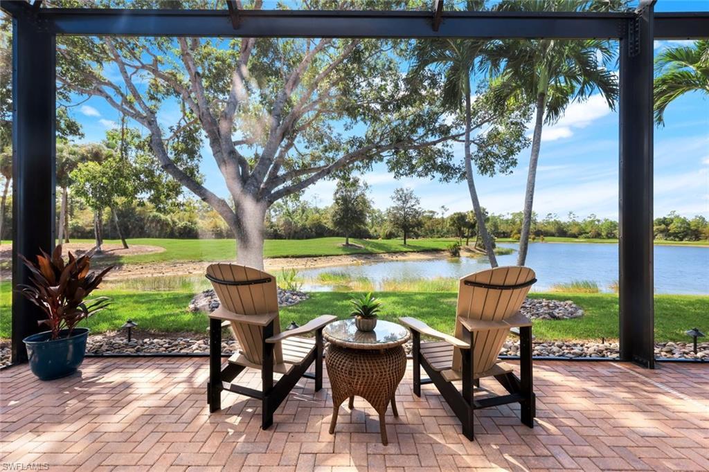 5092 Cerromar Drive Naples, FL 34112 - Photo 9 of 47 a view of chairs and table in patio with lake view