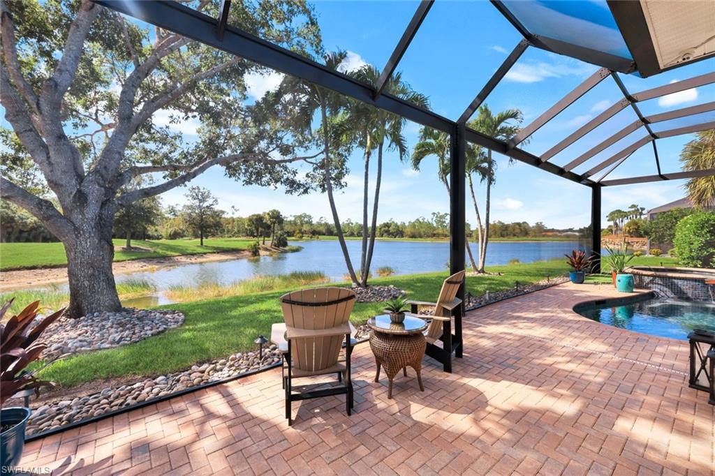 5092 Cerromar Drive Naples, FL 34112 - Photo 10 of 47 a view of swimming pool with outdoor seating and plants