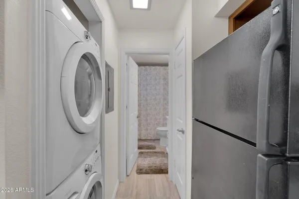 a bathroom with a granite countertop sink a toilet a mirror and shower