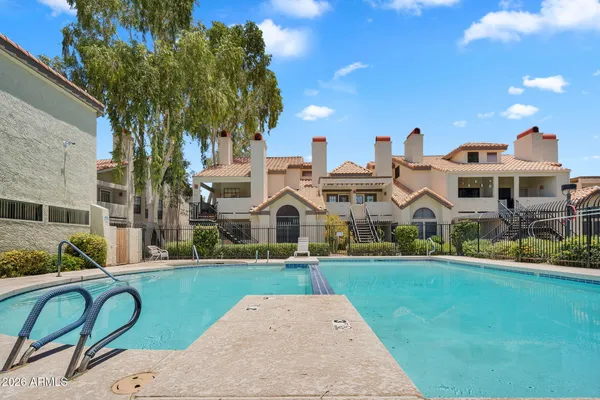 a swimming pool with outdoor seating and yard