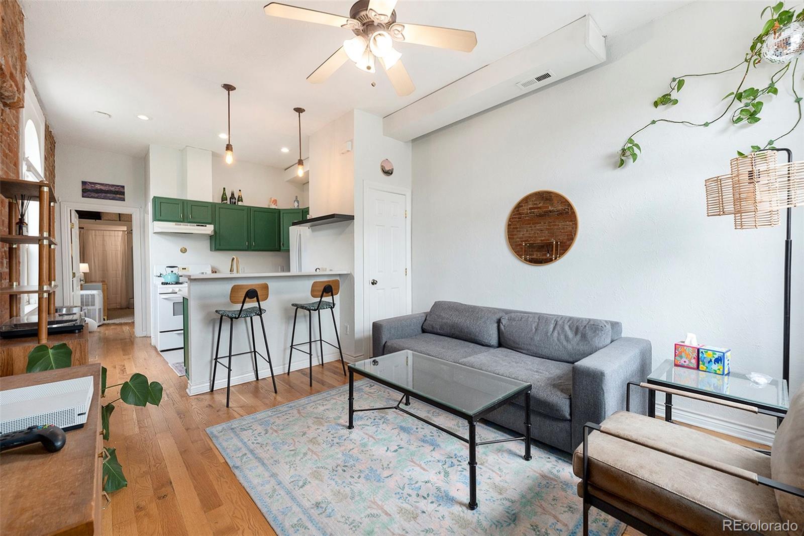 474 Inca Street Denver, CO 80204 - Photo 3 of 15 a living room with furniture and kitchen view