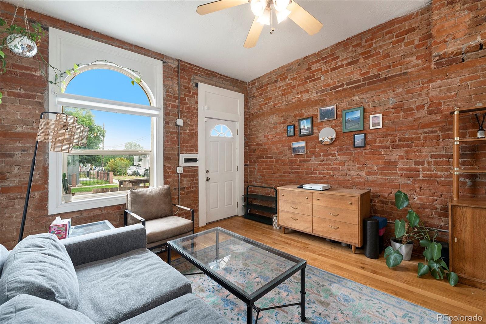 474 Inca Street Denver, CO 80204 - Photo 4 of 15 a living room with furniture and a fireplace