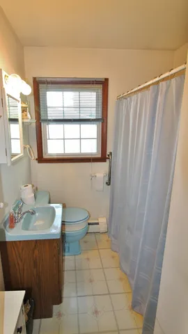 a bathroom with a sink a toilet and tub