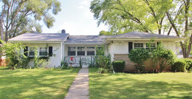 a front view of house with yard and green space