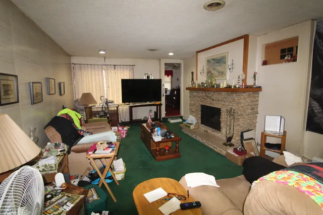a living room with furniture fireplace and a flat screen tv
