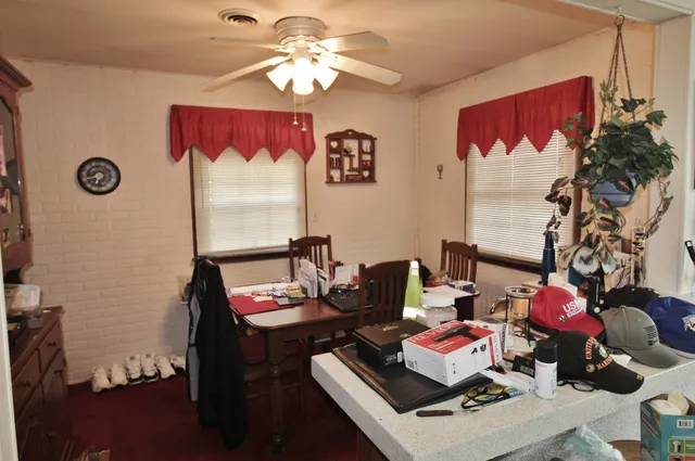 a room with furniture and view of kitchen