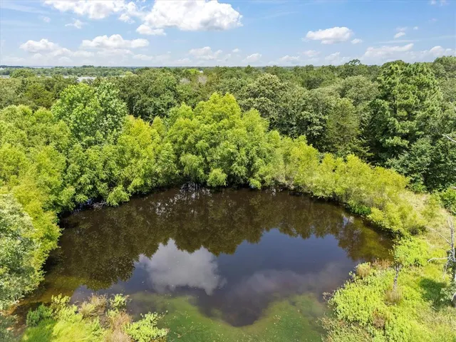 a view of a lake with houses in the back