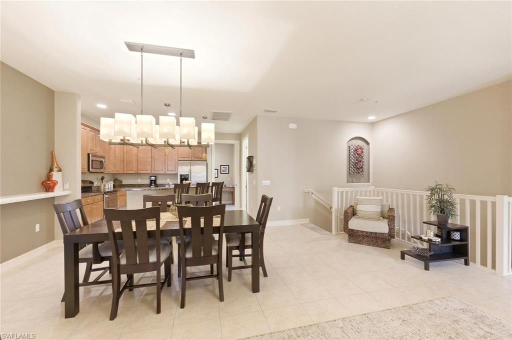 9140 Delano Street, Unit 9302 Naples, FL 34113 - Photo 13 of 40 a view of a dining room with furniture
