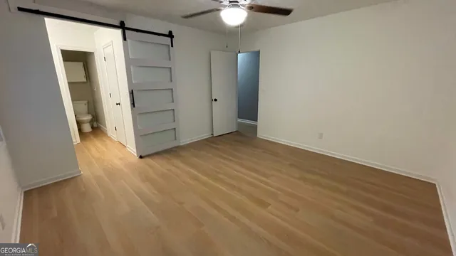 an empty room with wooden floor and cabinet