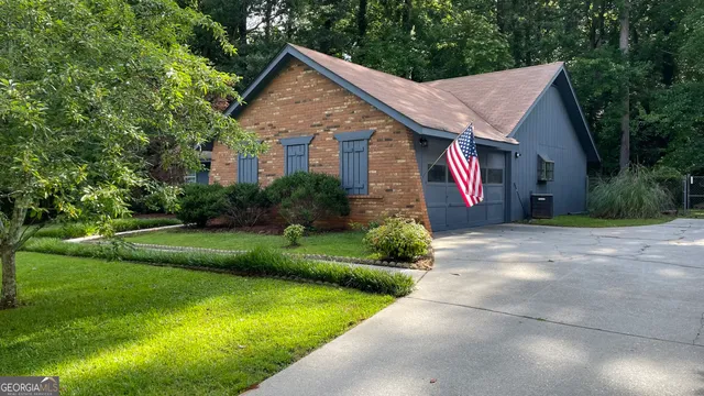 a view of a house with garden and yard