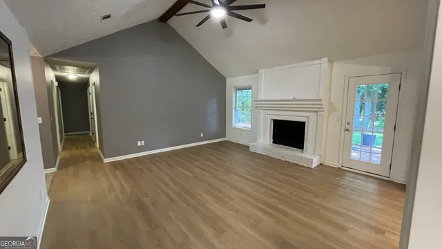 wooden floor fireplace and natural light in room