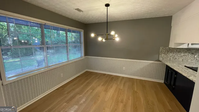 a bathroom with a sink and a wooden floor