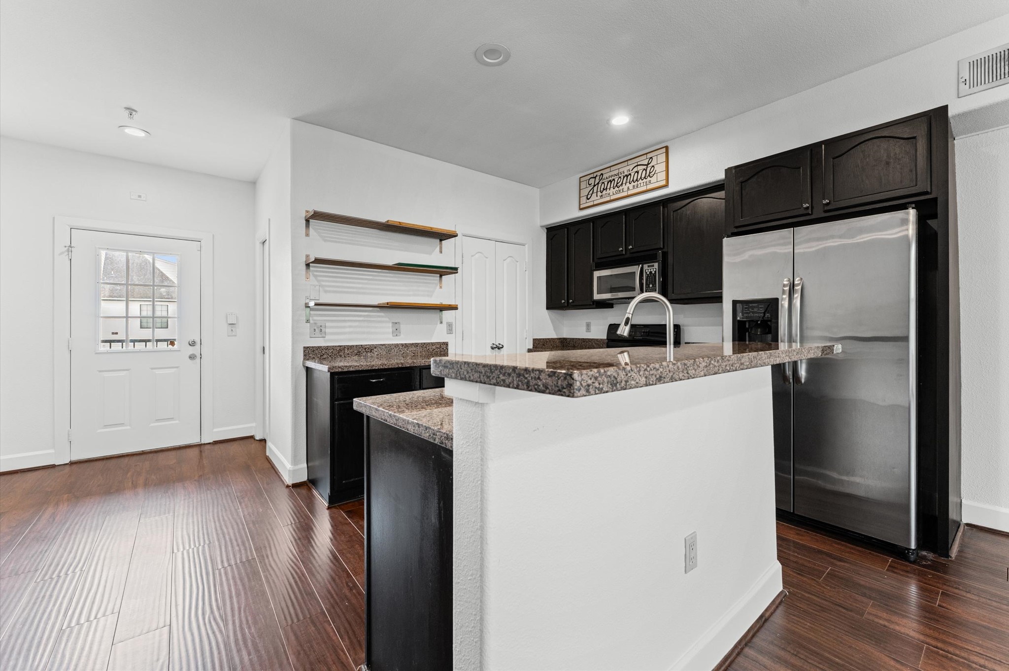 1602 Elgin Street, Unit 10 Houston, TX 77004 - Photo 6 of 21 The kitchen and living areas connect seamlessly, creating a comfortable, open feel throughout the unit's first floor.