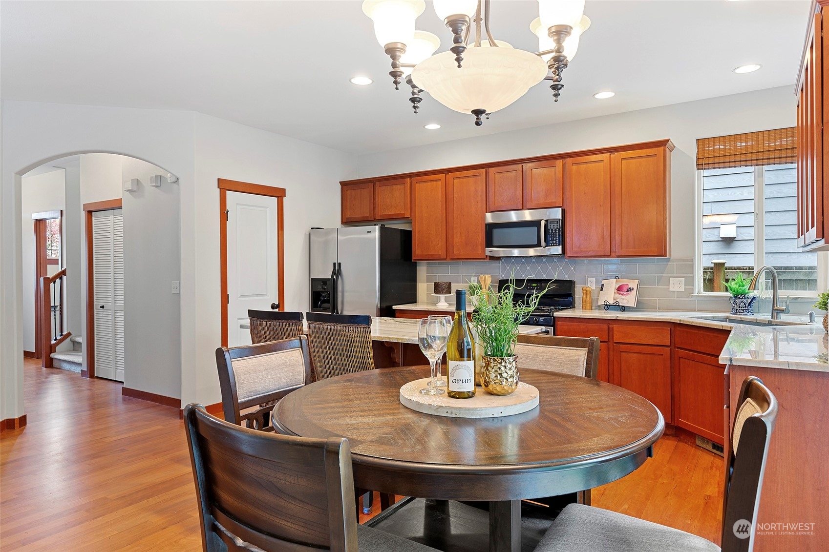 4518 147th Place Southeast Bothell, WA 98012 - Photo 12 of 36 a view of a dining room with furniture window and wooden floor