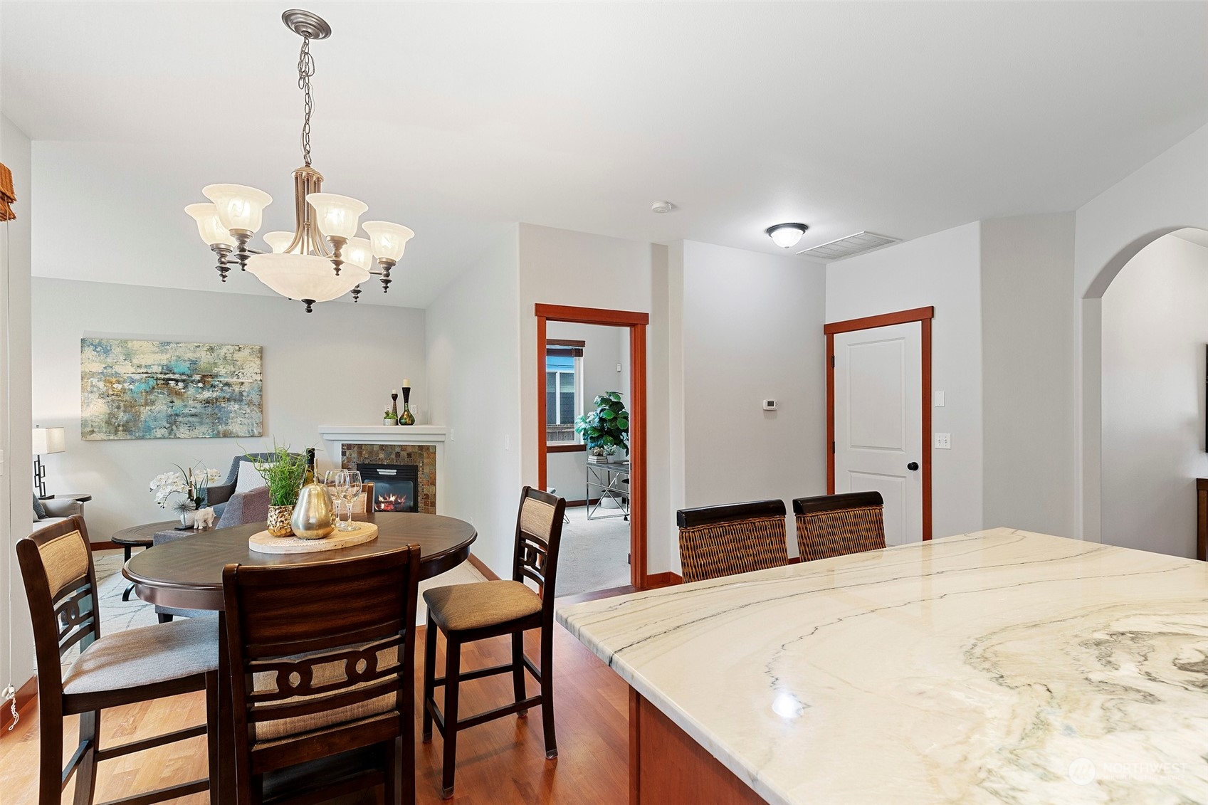 4518 147th Place Southeast Bothell, WA 98012 - Photo 10 of 36 a dining room with wooden floor a chandelier a wooden table and chairs
