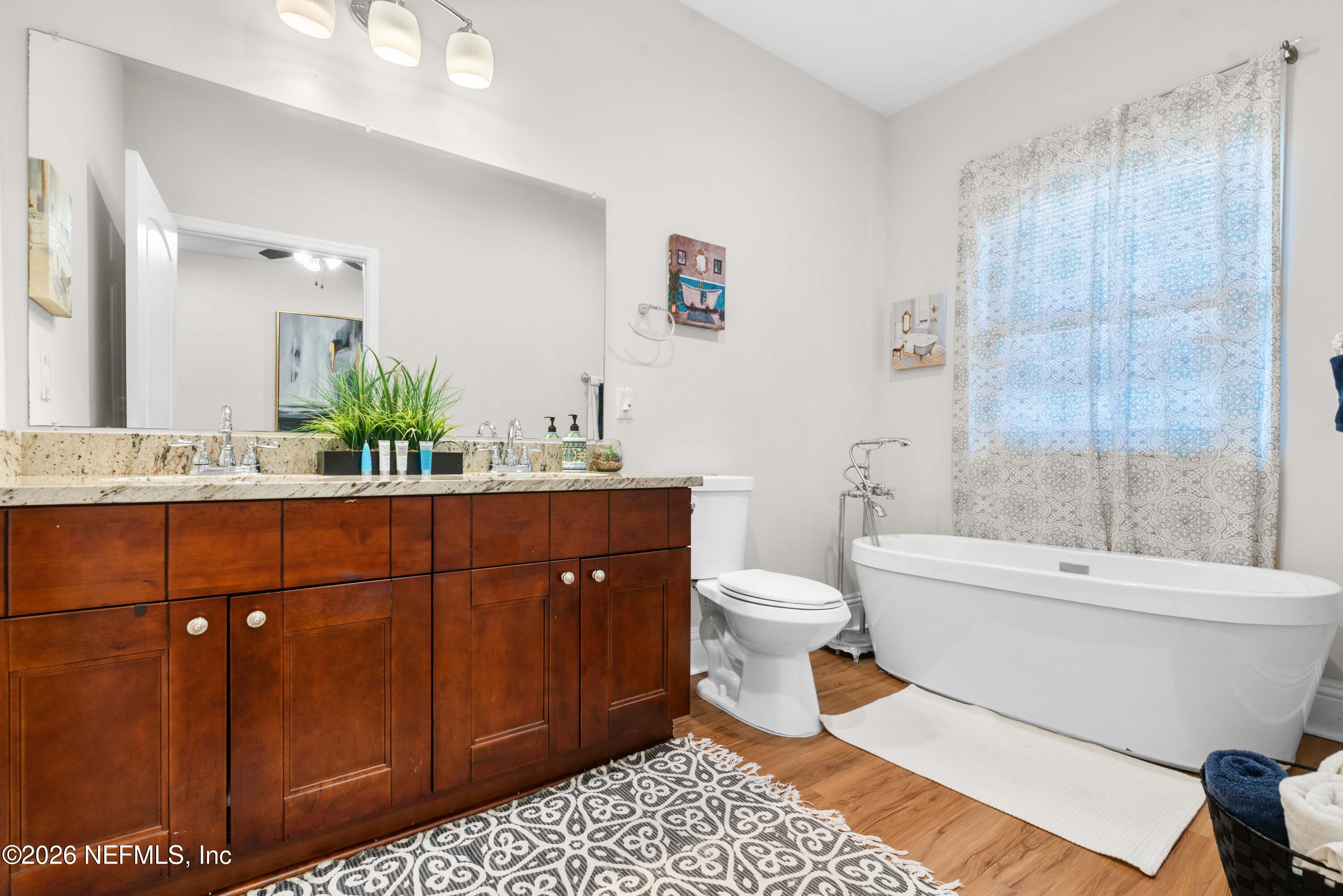 1138 Walnut Street Jacksonville, FL 32206 - Photo 28 of 37 a bathroom with a sink a toilet a mirror a bathtub and shower