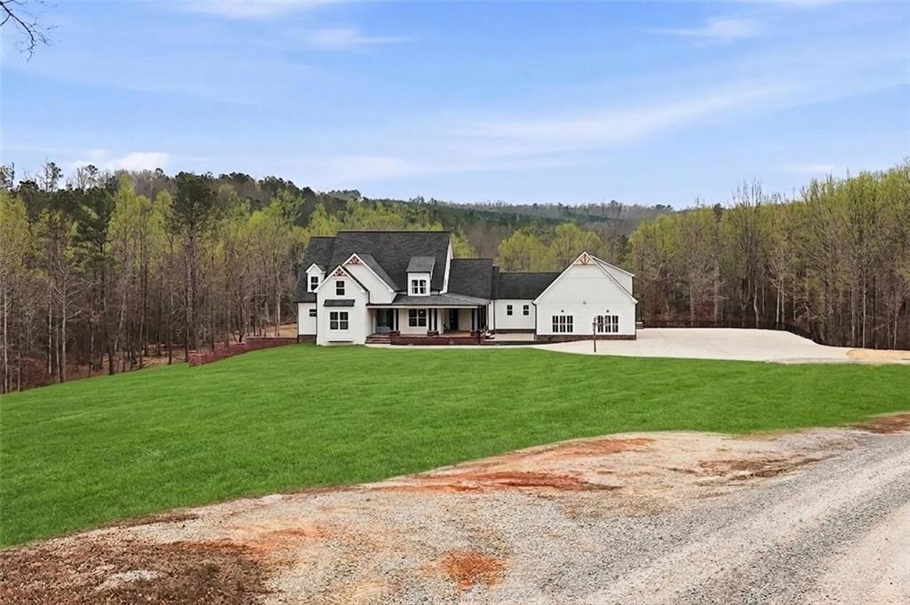 1100 Soap Creek Road Ball Ground, GA 30107 - Photo 12 of 107 a view of a big house with a big yard and a large trees