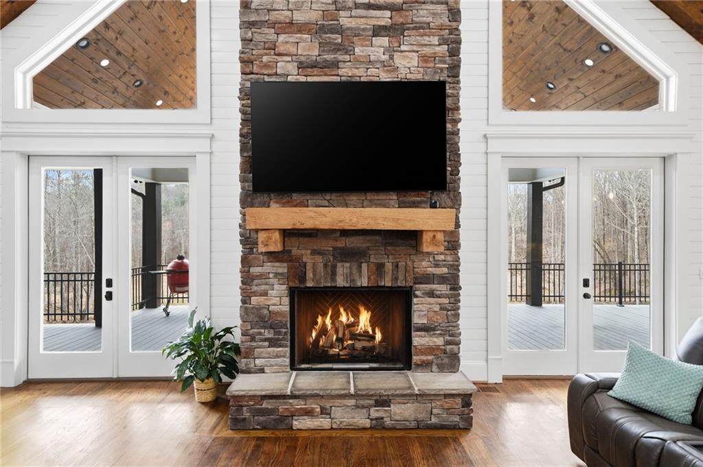 1100 Soap Creek Road Ball Ground, GA 30107 - Photo 24 of 107 a living room with furniture a flat screen tv and a fireplace