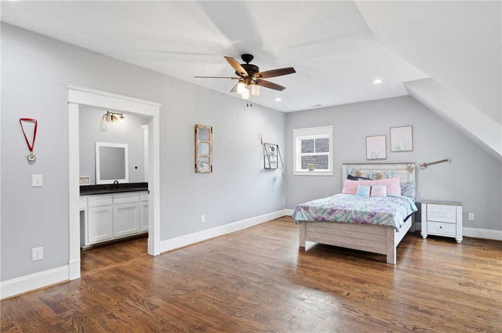 1100 Soap Creek Road Ball Ground, GA 30107 - Photo 47 of 107 a spacious bedroom with a bed and a chandelier