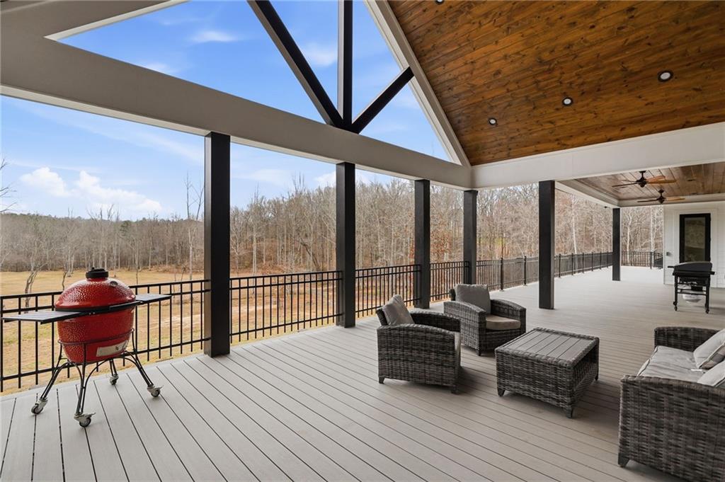 1100 Soap Creek Road Ball Ground, GA 30107 - Photo 55 of 107 a living room with furniture and floor to ceiling windows