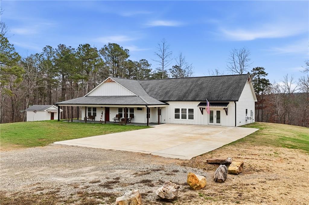 1100 Soap Creek Road Ball Ground, GA 30107 - Photo 68 of 107 a big house with a big yard and large trees
