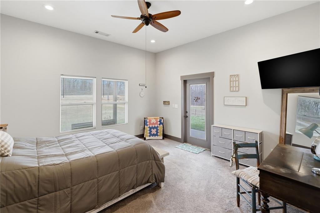 1100 Soap Creek Road Ball Ground, GA 30107 - Photo 88 of 107 a bedroom with a bed and a flat screen tv