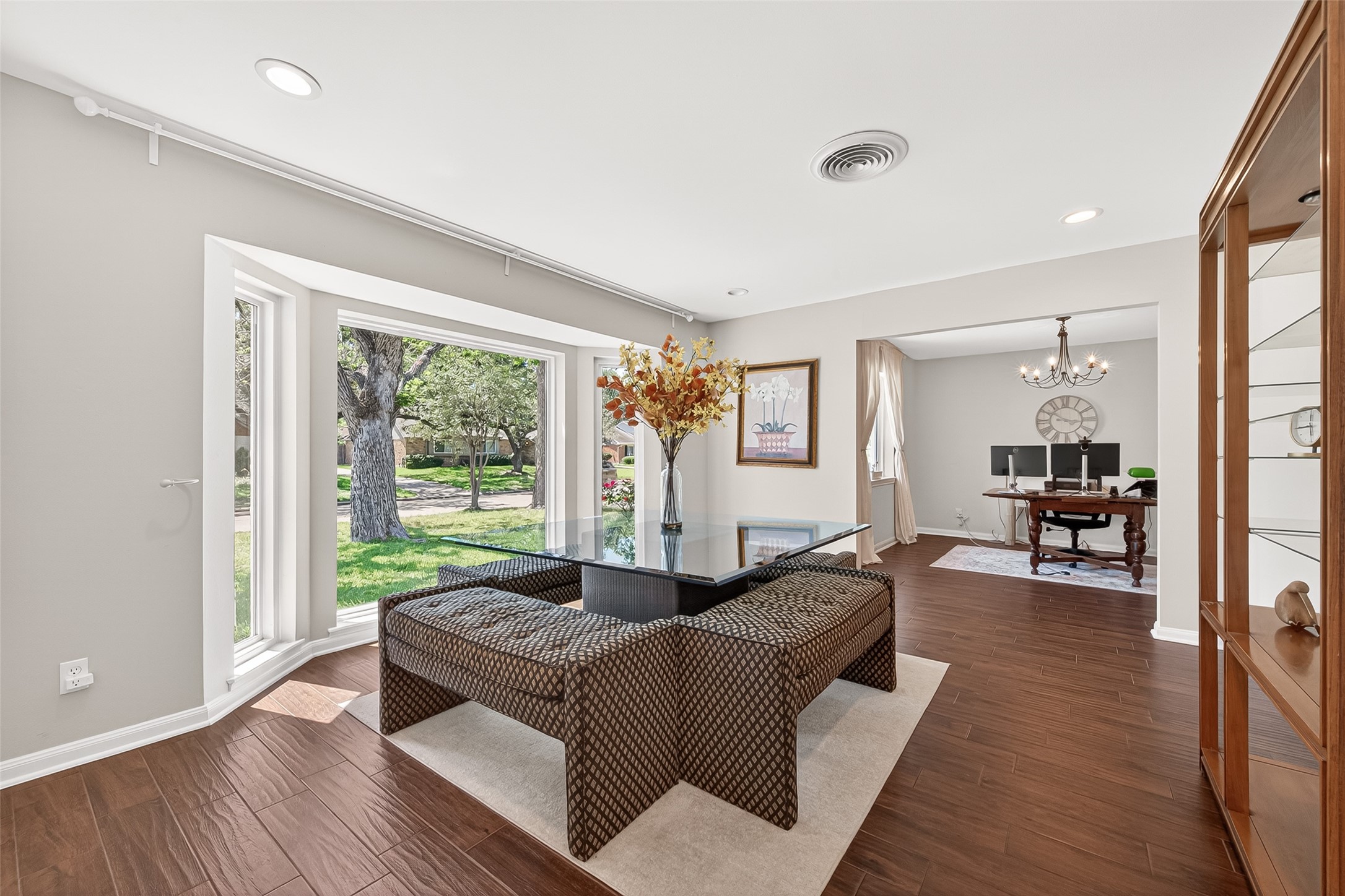 2610 Teague Road Houston, TX 77080 - Photo 3 of 49 Elegant formal living room positioned at the front of the home, featuring large bay windows that flood the space with natural light and create a warm, inviting atmosphere perfect for entertaining or everyday living.