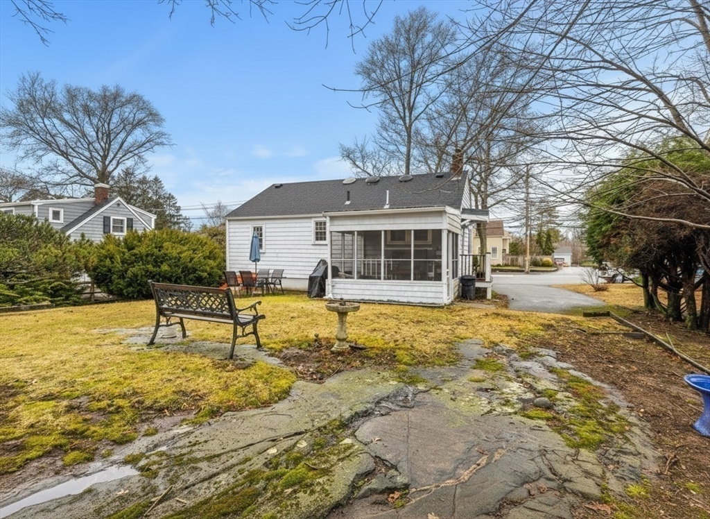 72 Village Street Marblehead, MA 01945 - Photo 18 of 22 a view of a house with pool and chairs next to a yard