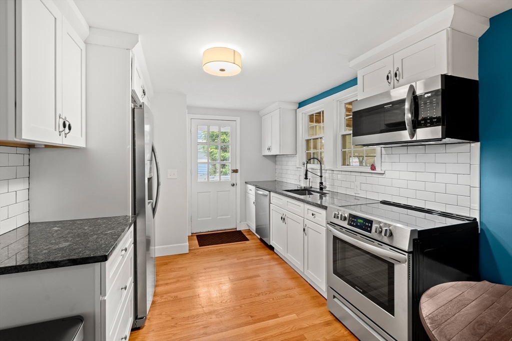 72 Village Street Marblehead, MA 01945 - Photo 7 of 22 a kitchen with stainless steel appliances granite countertop a stove a sink and a microwave