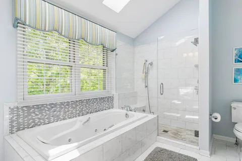 a bathroom with a bathtub and a shower
