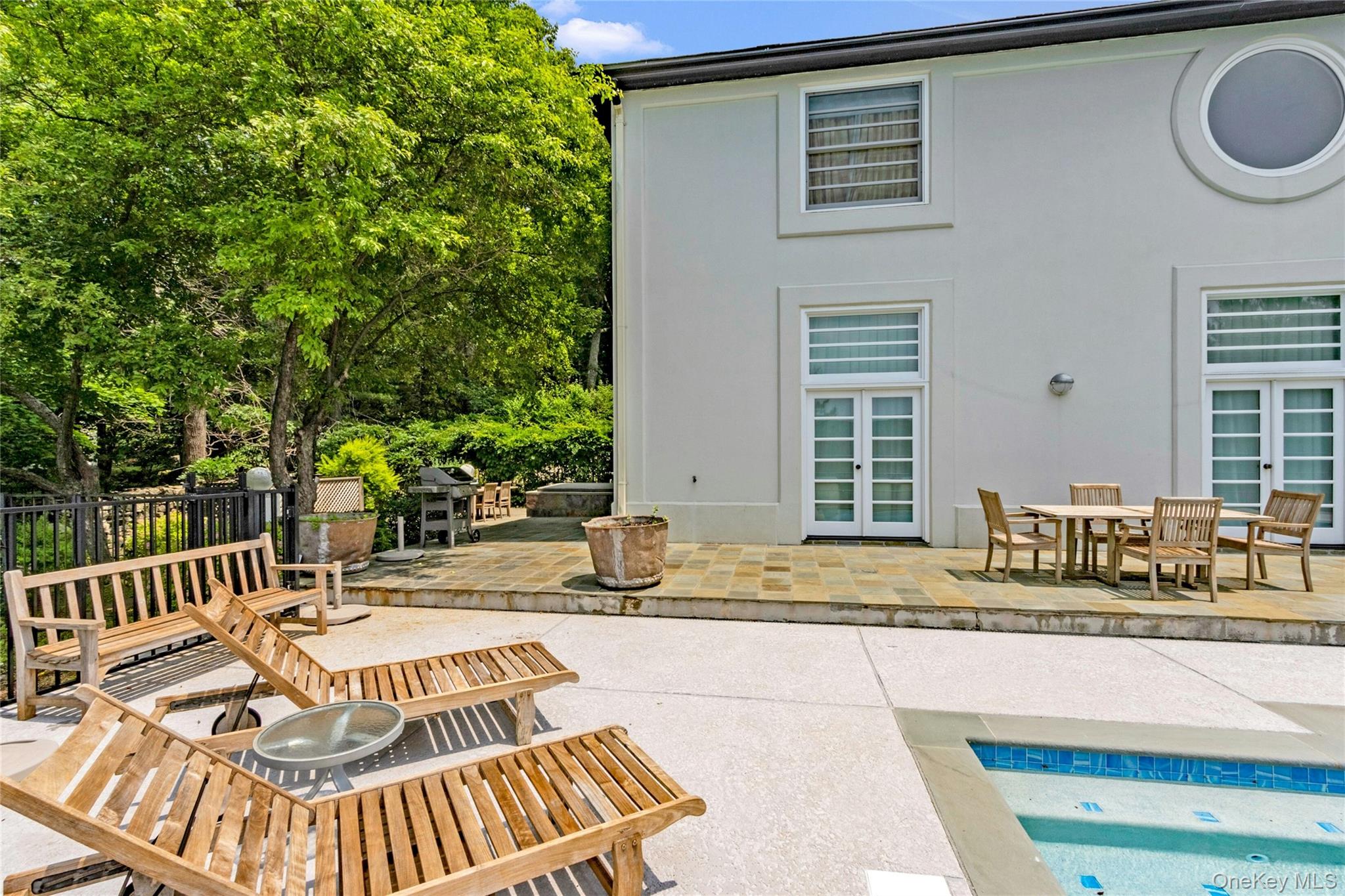 94 Cliff Road Tuxedo Park, NY 10987 - Photo 27 of 37 Back of house featuring french doors, a patio, stucco siding, and outdoor dining area