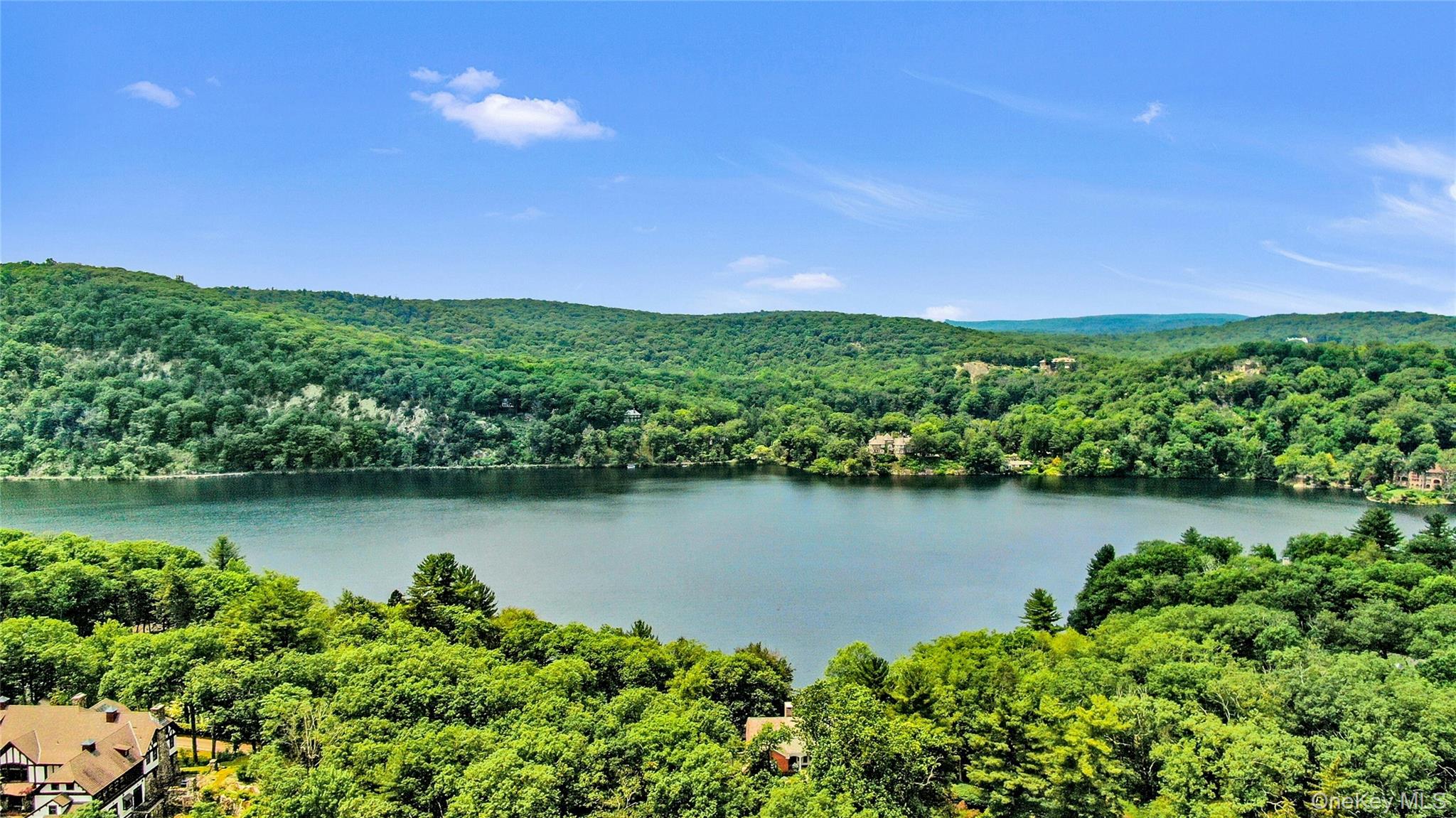 94 Cliff Road Tuxedo Park, NY 10987 - Photo 36 of 37 a view of a lake with a house in the background