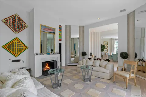 a living room with furniture a large window and wood floor