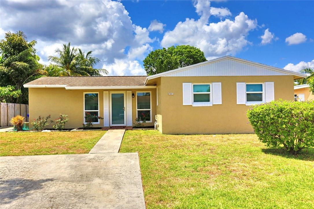 6960 Southwest 1st Street Margate, FL 33068 - Photo 1 of 36 a view of yellow house with a yard and potted plants