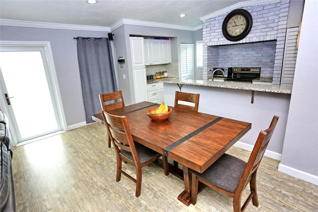 6960 Southwest 1st Street Margate, FL 33068 - Photo 12 of 36 a view of a dining room with furniture and a clock