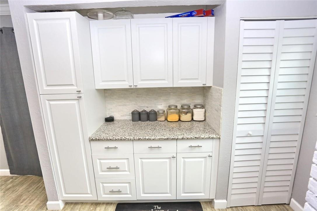 6960 Southwest 1st Street Margate, FL 33068 - Photo 15 of 36 a kitchen with granite countertop white cabinets and a window